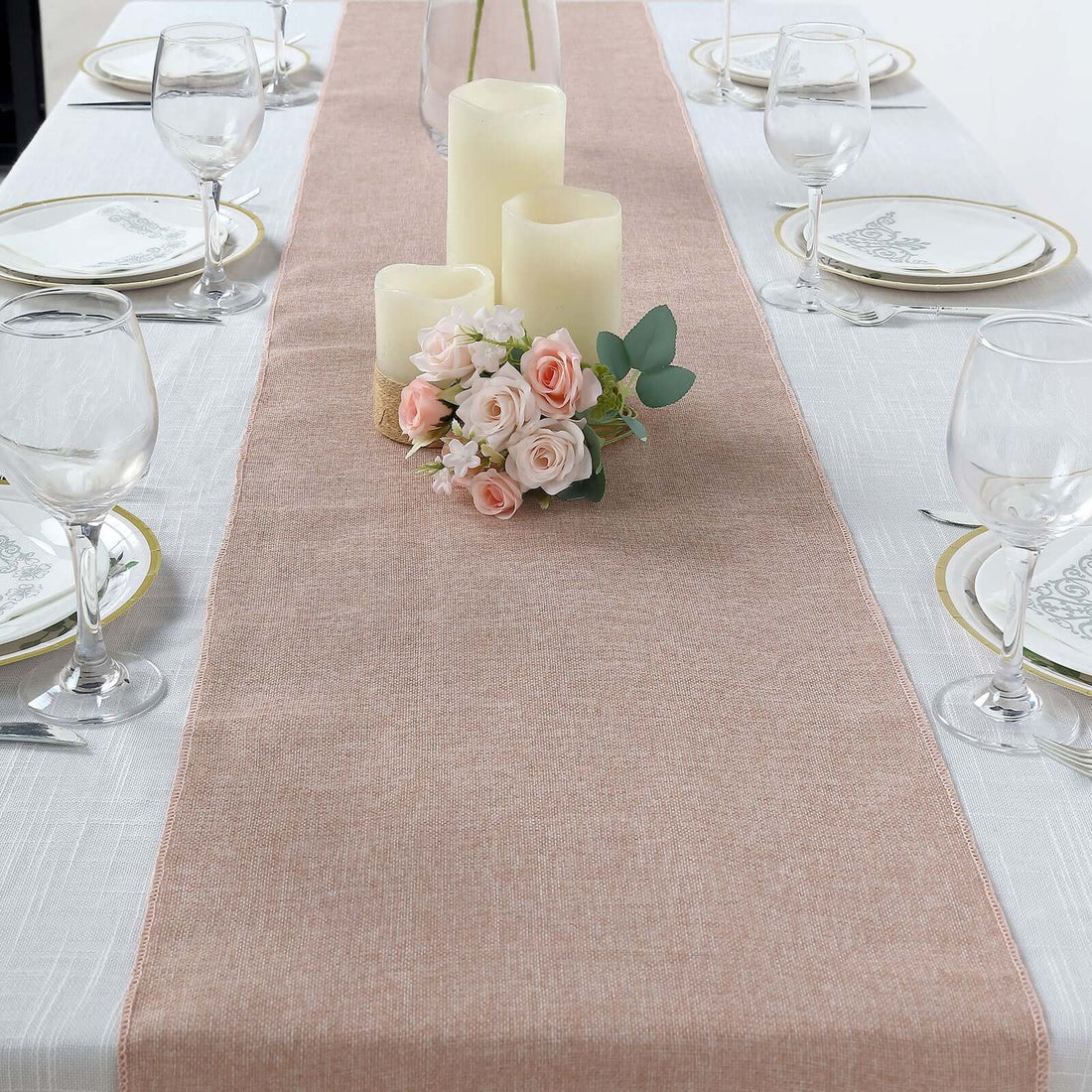 Elegant table runner with candles and floral arrangement on a dining table.