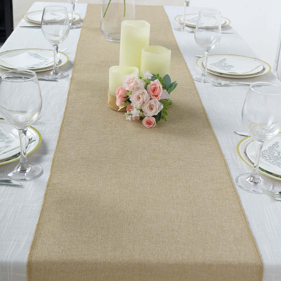 Table runner with candles and flowers on a dining table setting.