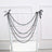 Black bead chair decoration with bows, cascading elegantly over a white chair.