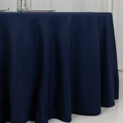 Navy blue tablecloth draping elegantly over a round table.