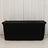 Black table cover draped over a table in studio setting.