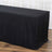 Black tablecloth draped over a table with a wooden floor backdrop.