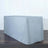 Gray table cover draping over a rectangular table on a wooden floor.