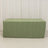 Green tablecloth draped over a rectangular table on a plain backdrop.