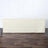 Cream table cover on a wooden floor with a simple backdrop.