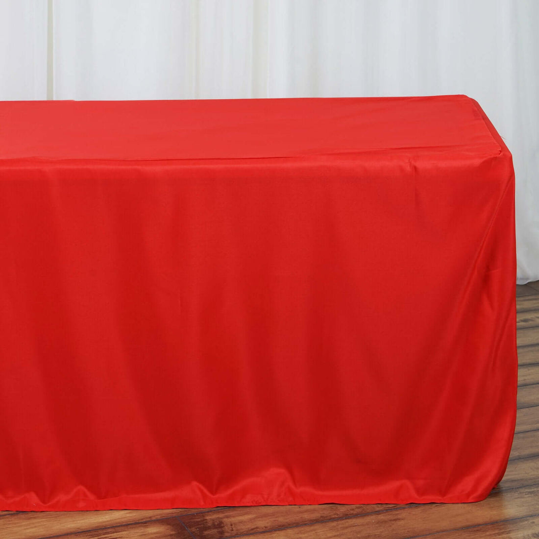 Red tablecloth draped over a table, creating a vibrant display.