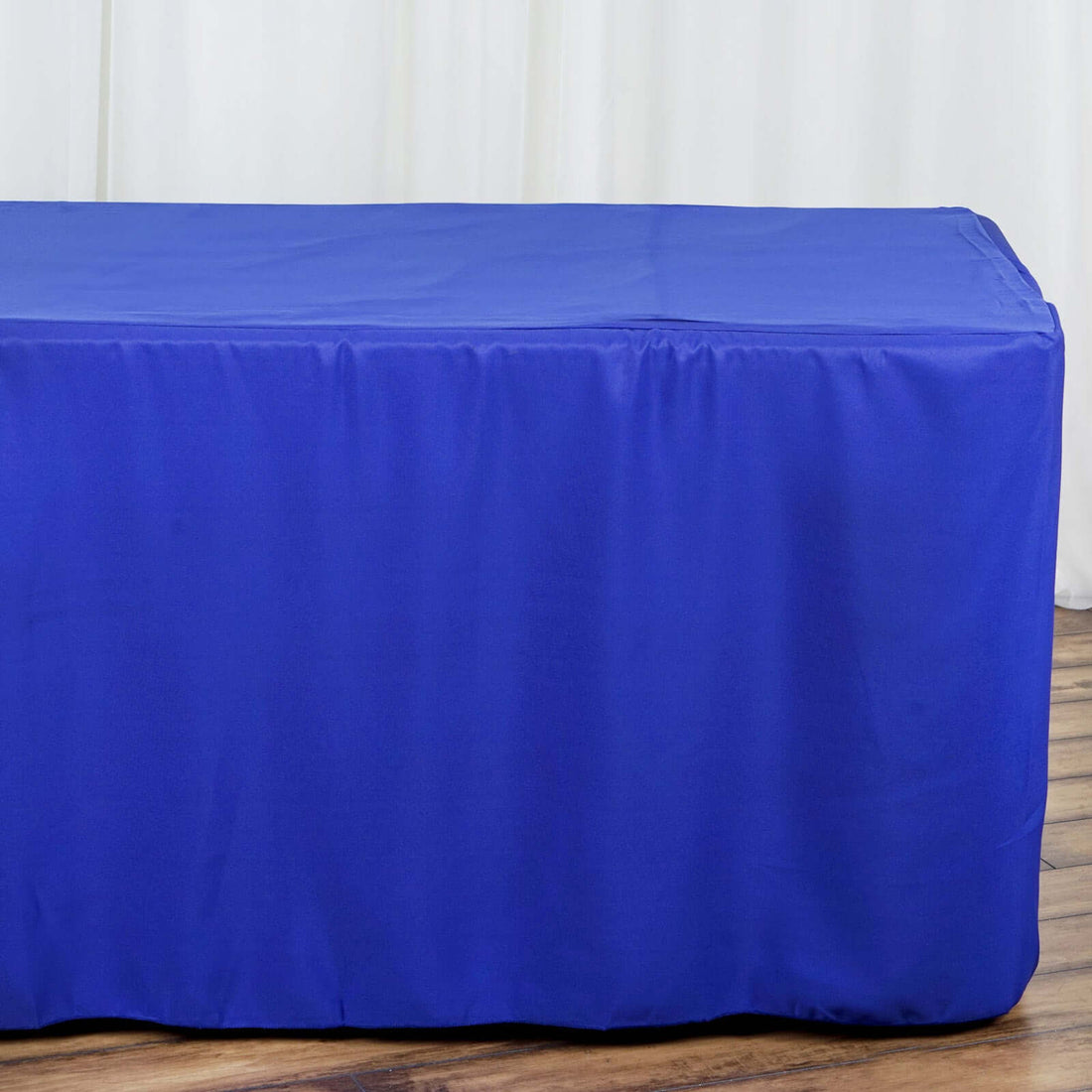 Blue table cover on a wooden floor backdrop.