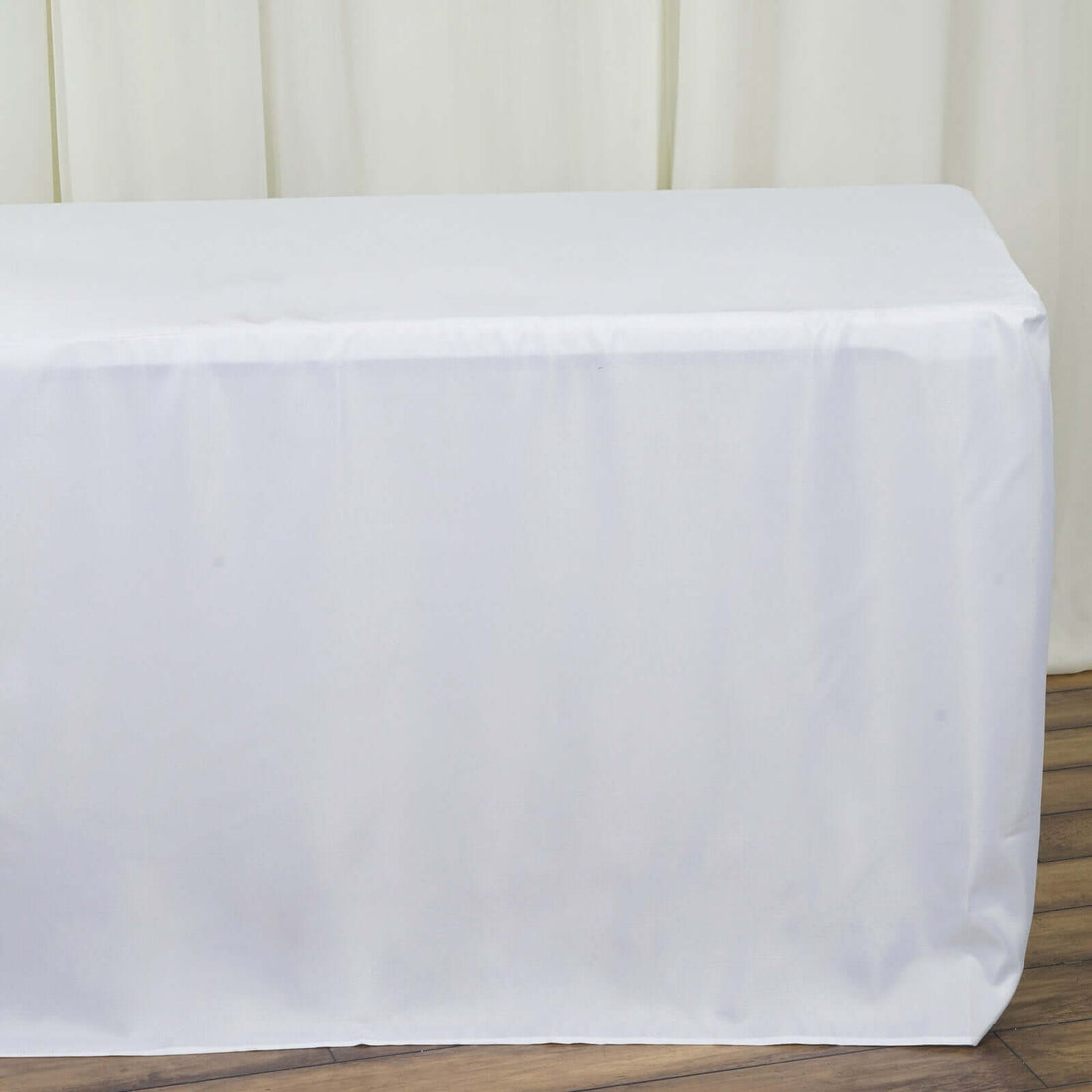 White tablecloth draped over a table for events or dining.