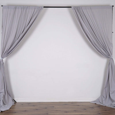 Gray fabric curtains draped on a backdrop support frame