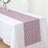 Lace table runner in mauve color on a white tablecloth