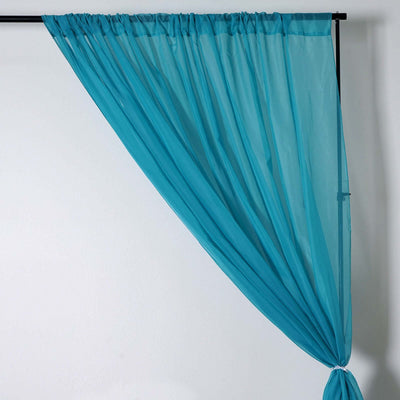 Sheer turquoise curtain draped elegantly on a black rod.
