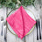 Pink dinner napkin elegantly folded on a decorative plate with cutlery. #whtbkgd