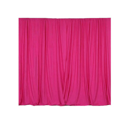 Pink fabric curtain draped elegantly in a studio-style shot.