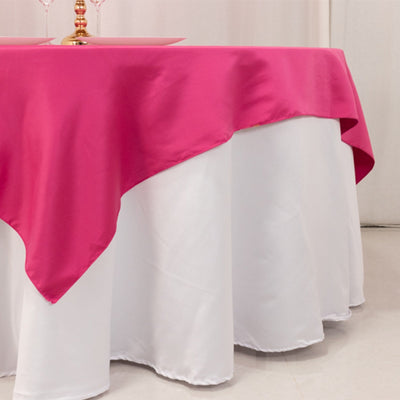 Pink tablecloth draped over a white table for elegant dining setups.