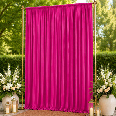 Fuchsia wedding backdrop curtain with gold frame and floral arrangements