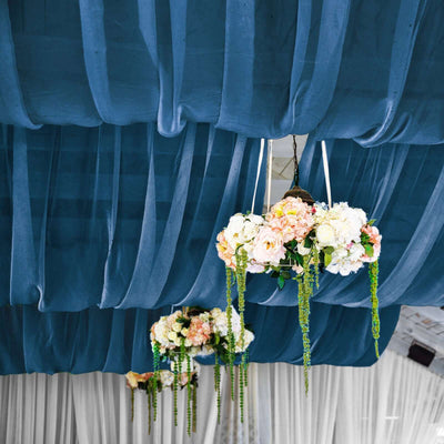 Elegant floral chandelier decor with draped fabric backdrop.
