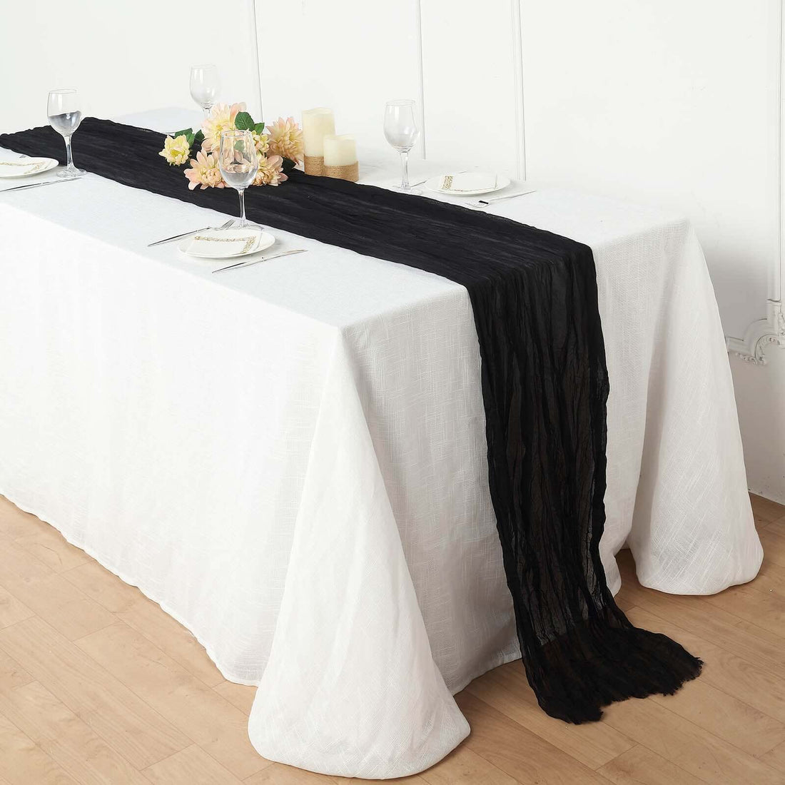 Black table runner draping elegantly over a white tablecloth.