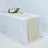 Elegant beige table runner on a white table with floral decor and glassware.