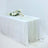 Elegant dining table setup with floral arrangement and candles on a white tablecloth.