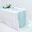 Elegant aqua table runner on a white table with floral decor and glassware.