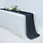 Black pleated table runner on a white table with floral decor and glassware.