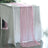 Pink table runner draped elegantly over a white table.