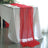 Red table runner draped elegantly over a white table setting.