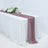 Elegant table setting with a mauve runner and floral decor