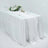 Elegant white table setup with floral arrangement and glassware.