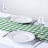 White plates and glasses on a green checkered table runner.
