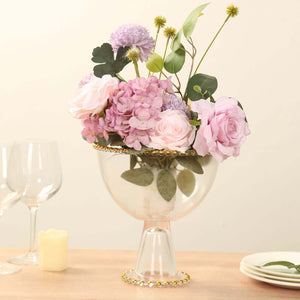Elegant floral arrangement in a glass vase with decorative accents.