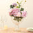 Elegant floral arrangement in a glass vase with decorative accents.