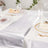 Elegant dining table setup with silver table runner and decorative plates.