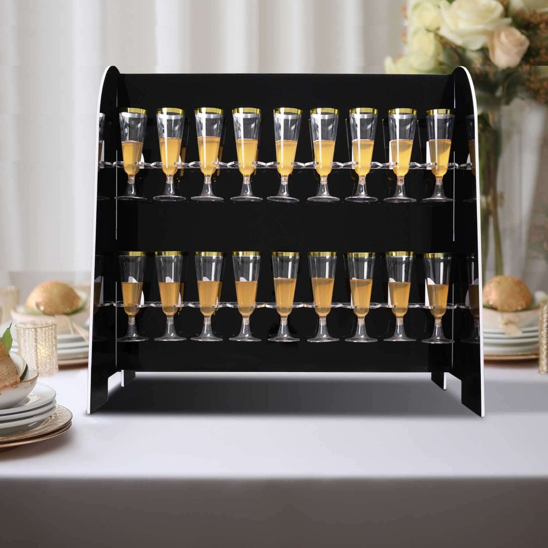 Champagne tower with glasses filled with orange juice on a table