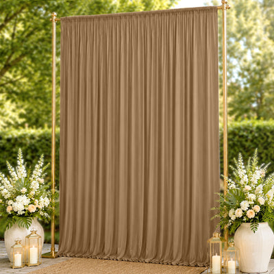 Gold backdrop curtain with floral arrangements and lanterns outdoors