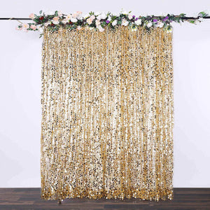 Gold sequin curtain with floral top decoration for events and parties.