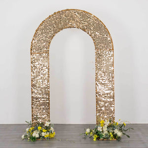 Gold sequin wedding backdrop arch with floral arrangements on the base.