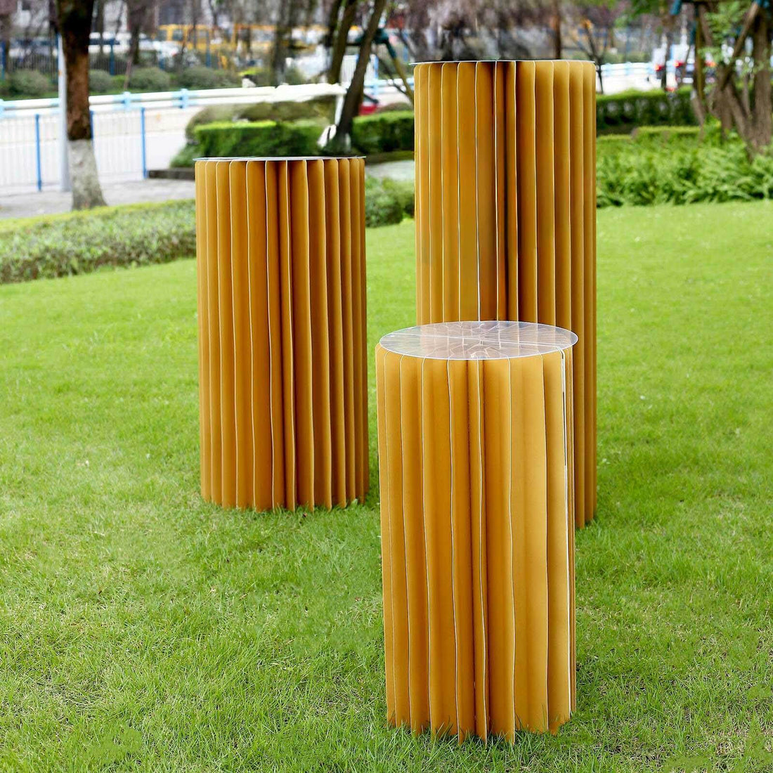 Modern yellow folding tables in a garden setting.
