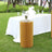 Stylish round gold table with pleated design, set in an outdoor event setting.