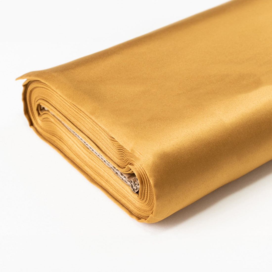 Gold satin fabric roll on a white background.