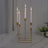 Elegant gold candle holder with five lit candles.