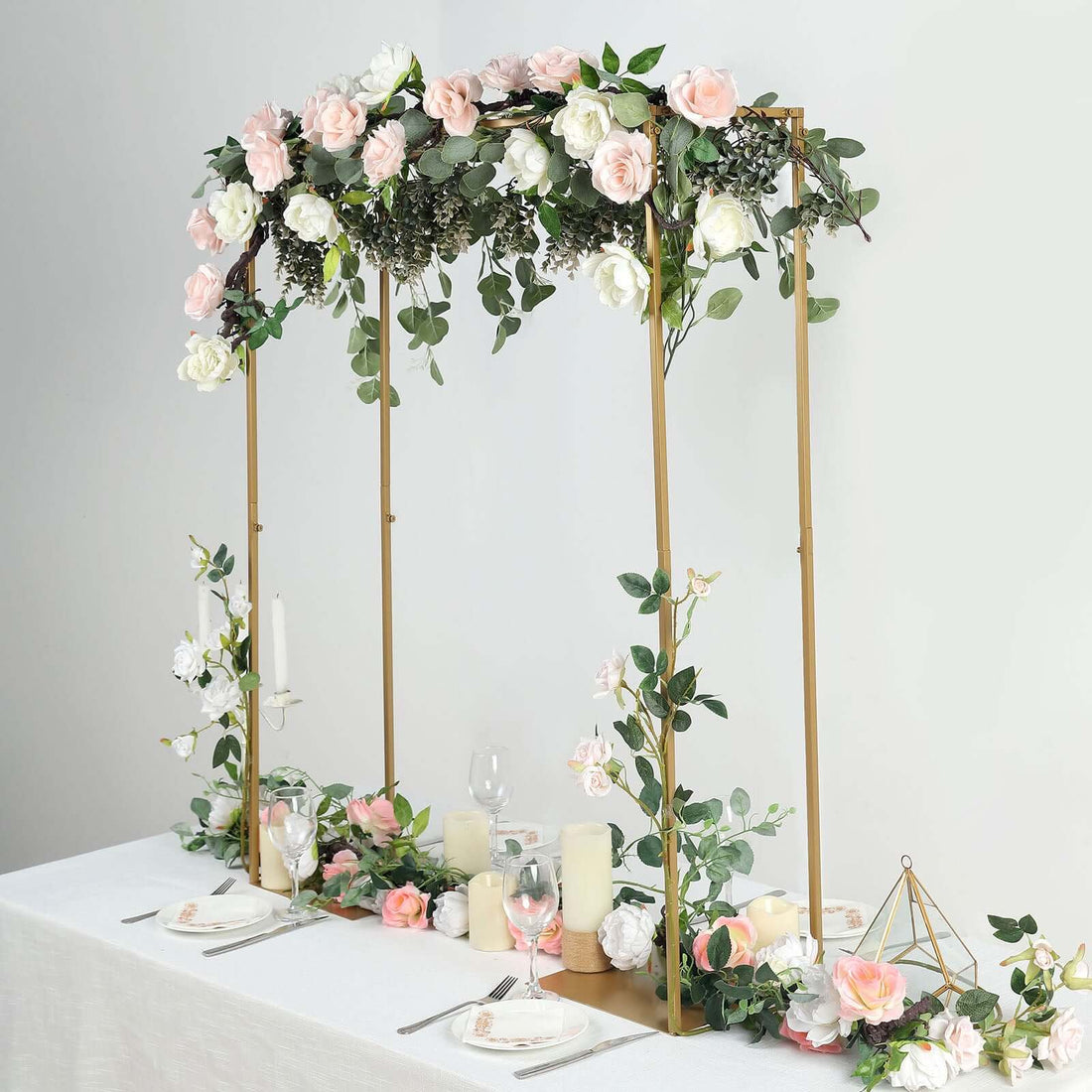 Elegant floral arch decoration for events with roses and greenery.