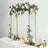 Elegant floral arch decoration for events with roses and greenery.