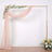 Elegant wedding arch with draped fabric and floral arrangement