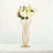 Gold flower stand with white and pink floral arrangement