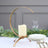 Gold candle holder with ivory candle, elegant dining setup.