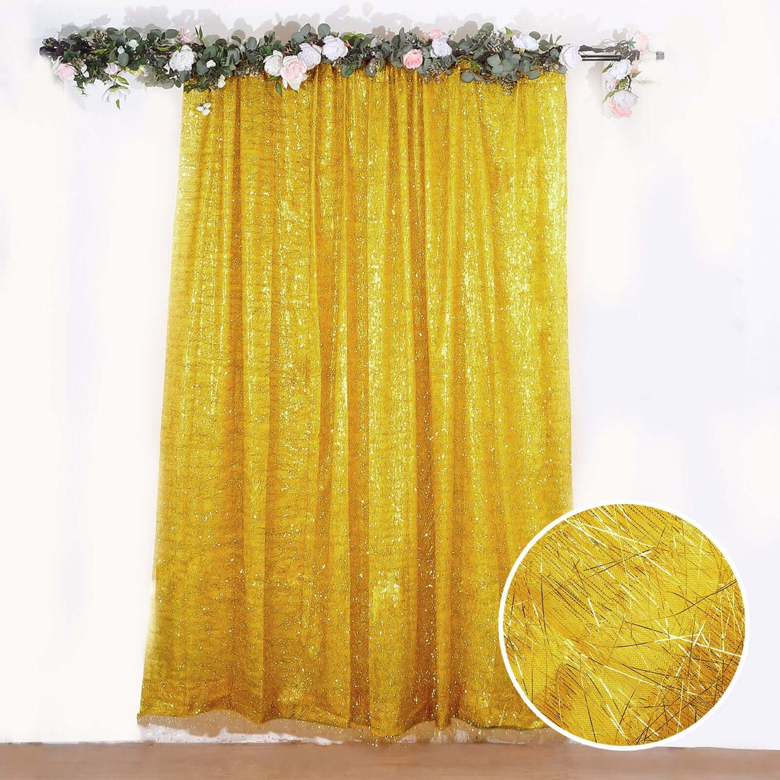 Gold shimmer curtain with decorative floral top.