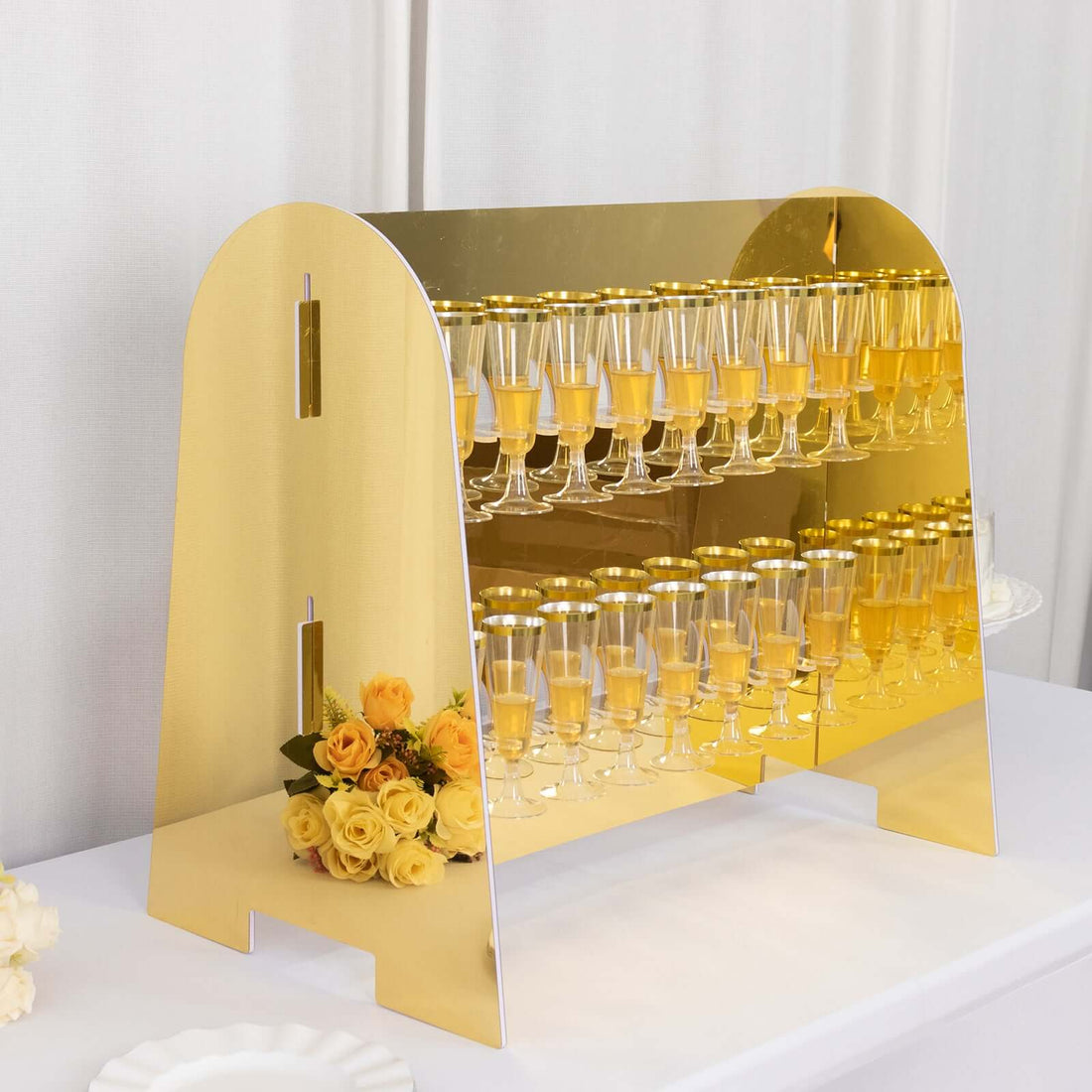 Gold champagne tower with glasses and roses, perfect for events and celebrations.