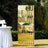 Gold champagne tower display at outdoor event with white table setup.