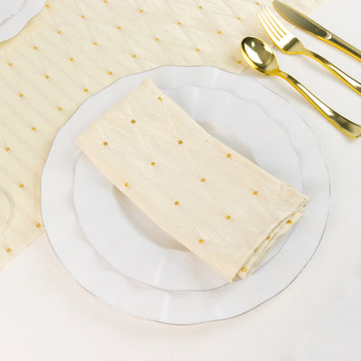 Gold polka dot napkin on white plate with gold cutlery set